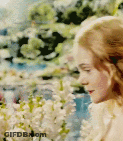 Woman Standing In Field Of Flowers GIF