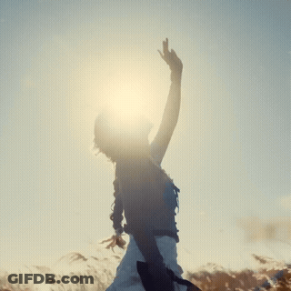 Woman Standing In Field With Arms Outstretched GIF