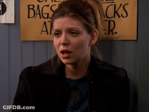 Woman Standing In Front Of Bags Sign GIF
