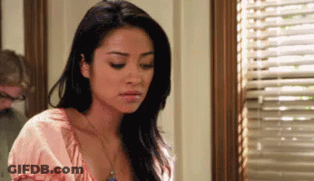Woman Standing In Front Of Blinds GIF
