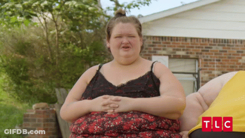 Woman Standing In Front Of Brick House With TLC GIF