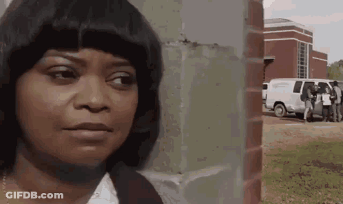 Woman Standing In Front Of Brick Wall GIF