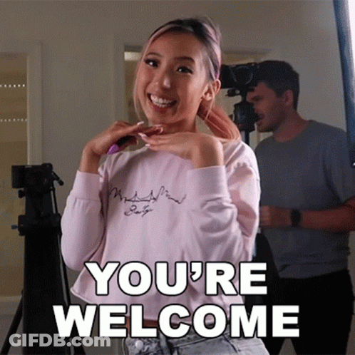 Woman Standing In Front Of Camera Saying You're Welcome GIF