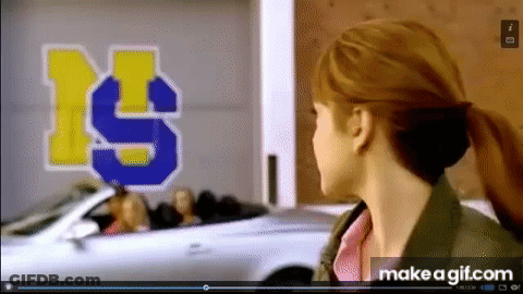 Woman Standing In Front Of Car With Number 19 GIF