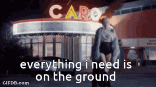 Woman Standing In Front Of Caro Building GIF