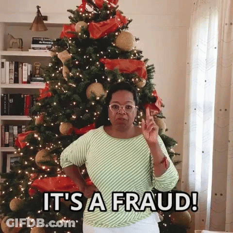 Woman Standing In Front Of Christmas Tree Saying It's A Fraud GIF