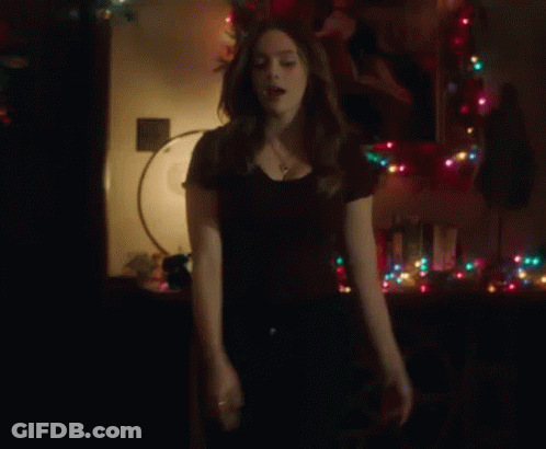 Woman Standing In Front Of Christmas Tree GIF
