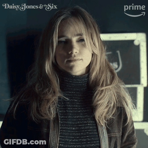 Woman Standing In Front Of Daisy Jones And The Six GIF