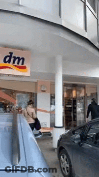 Woman Standing In Front Of DM Store GIF