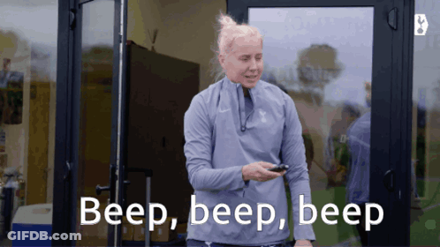 Woman Standing In Front Of Door Saying Beep Beep Beep GIF