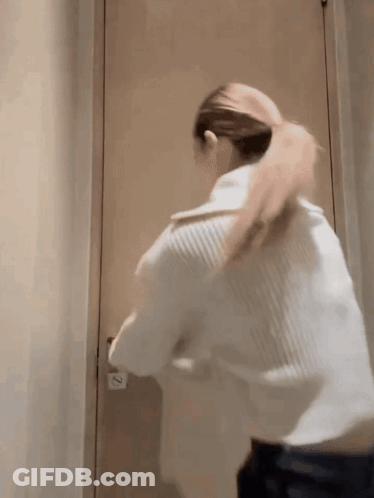 Woman Standing In Front Of Door With Number 2 GIF