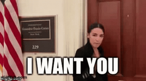 Woman Standing In Front Of Door With Sign Saying I Want You GIF