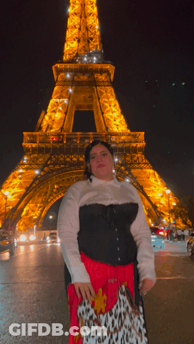 Woman Standing In Front Of Eiffel Tower GIF