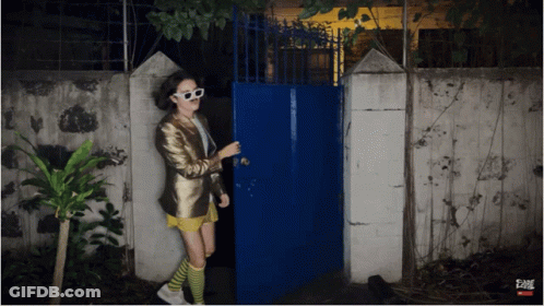 Woman Standing In Front Of Fame Gate GIF