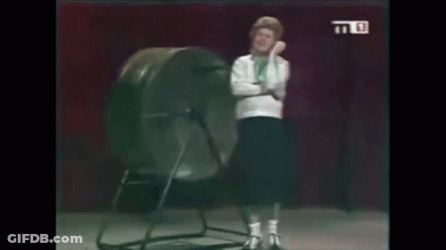 Woman Standing In Front Of Giant Wheel GIF