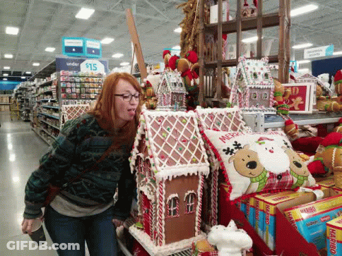 Woman Standing In Front Of Gingerbread House GIF