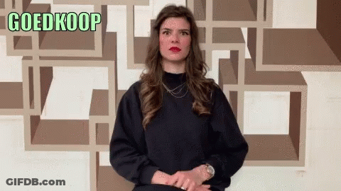 Woman Standing In Front Of Goedkoop Wall GIF
