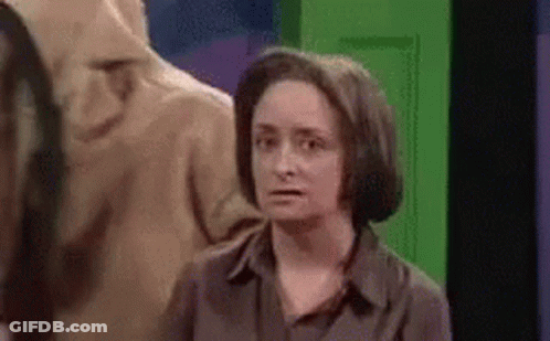 Woman Standing In Front Of Green Door GIF