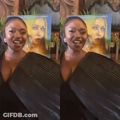 Woman Standing In Front Of Her Poster GIF