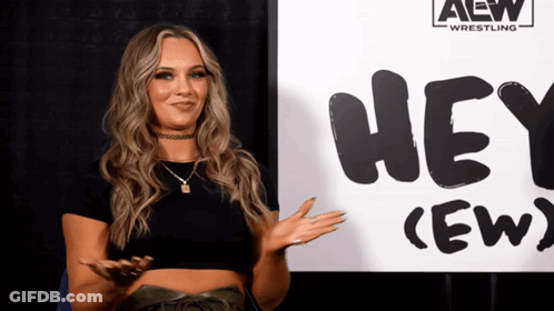 Woman Standing In Front Of Hey (Ew) Sign GIF