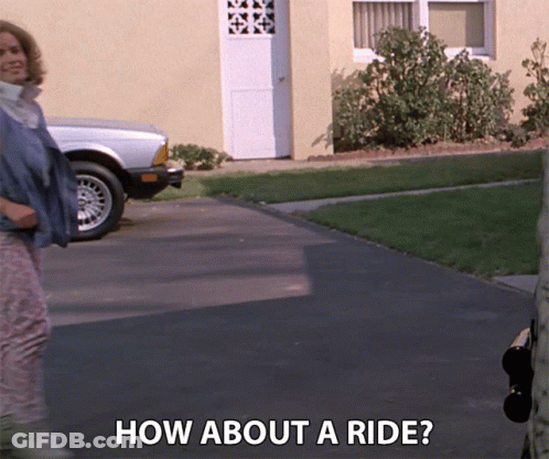 Woman Standing In Front Of House How About A Ride GIF