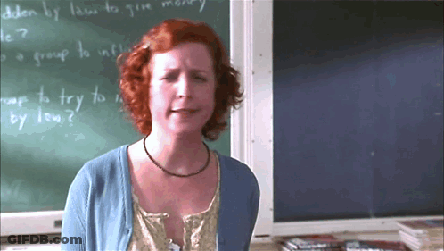 Woman Standing In Front Of How To Give Money Chalkboard GIF