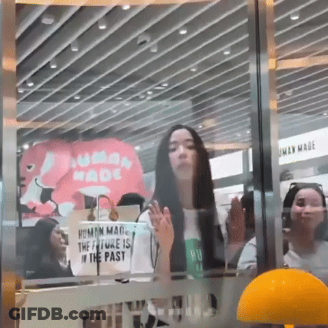 Woman Standing In Front Of Human Made Sign GIF