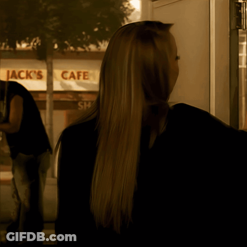 Woman Standing In Front Of Jack's Cafe GIF