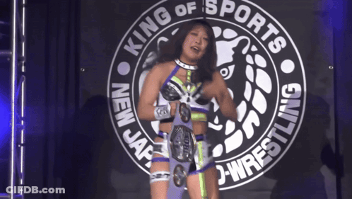Woman Standing In Front Of King Of Sports Sign GIF