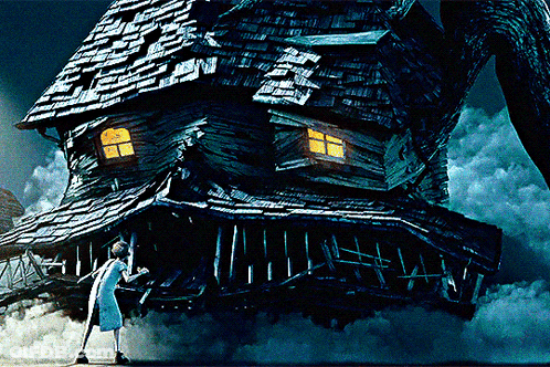 Woman Standing In Front Of Large House GIF