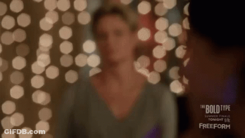 Woman Standing In Front Of Lights GIF