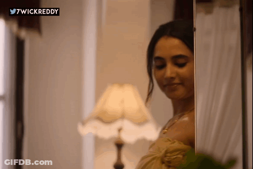 Woman Standing In Front Of Mirror GIF