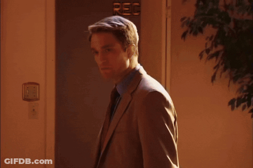 Woman Standing In Front Of Mirror In Dark Room GIF