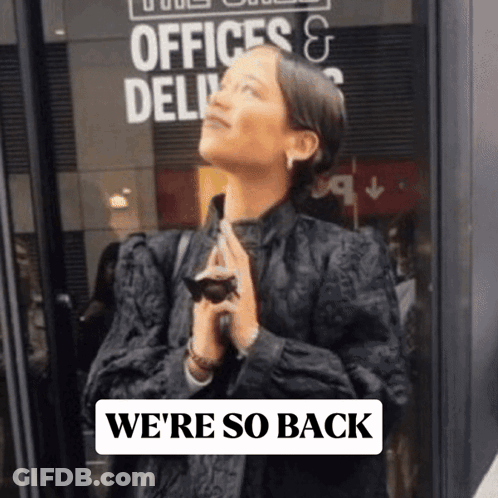 Woman Standing In Front Of Offices & Delivery Sign GIF