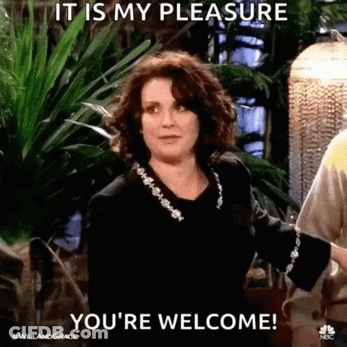 Woman Standing In Front Of Plant Saying You're Welcome GIF
