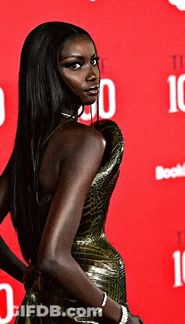 Woman Standing In Front Of Red Background With Number 10 GIF