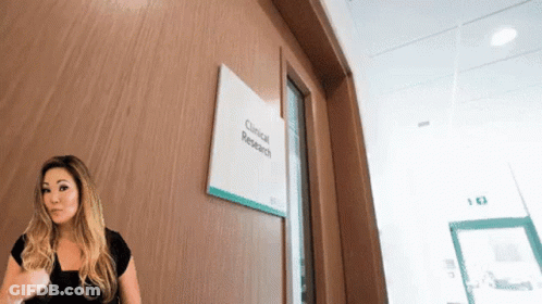 Woman Standing In Front Of Research Door GIF