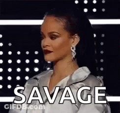 Woman Standing In Front Of Savage Text GIF
