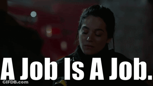 Woman Standing In Front Of Sign Saying A Job Is A Job GIF
