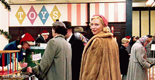 Woman Standing In Front Of Sign Saying Toys GIF