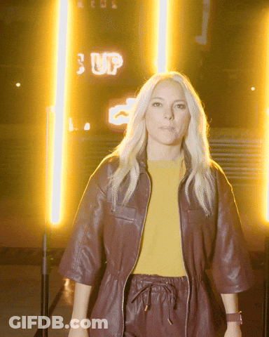 Woman Standing In Front Of Sign Saying Up GIF