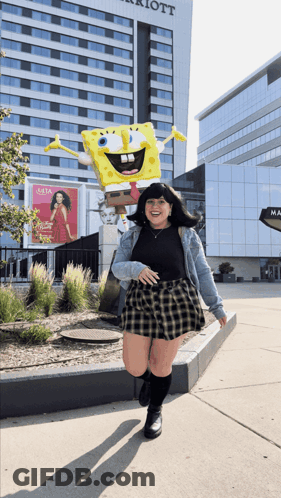 Woman Standing In Front Of SpongeBob Statue GIF
