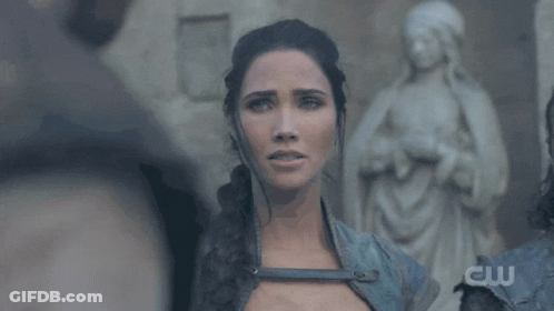 Woman Standing In Front Of Statue With Letters CW GIF