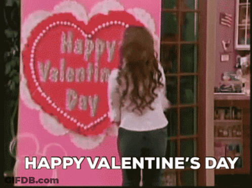 Woman Standing In Front Of Valentine's Day Card GIF