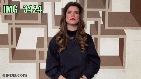 Woman Standing In Front Of Wall With Numbers IMG 34224 GIF
