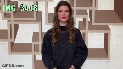 Woman Standing In Front Of Wall With Watermark Img_3402 GIF
