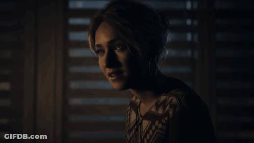 Woman Standing In Front Of Window With Blinds GIF