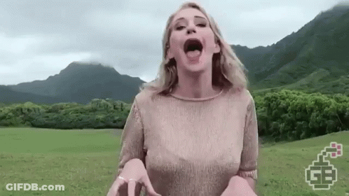 Woman Standing In Grassy Field Mouth Open GIF