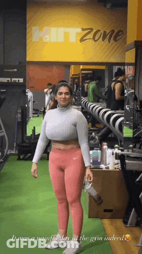 Woman Standing In Gym With Hitzone Sign GIF