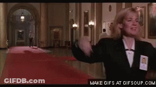 Woman Standing In Hallway Arms Outstretched GIF